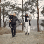 cute family in stylish clothes walking in a forest